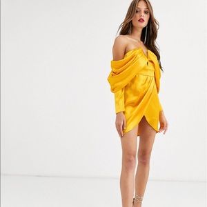 Gold draped shoulder dress.